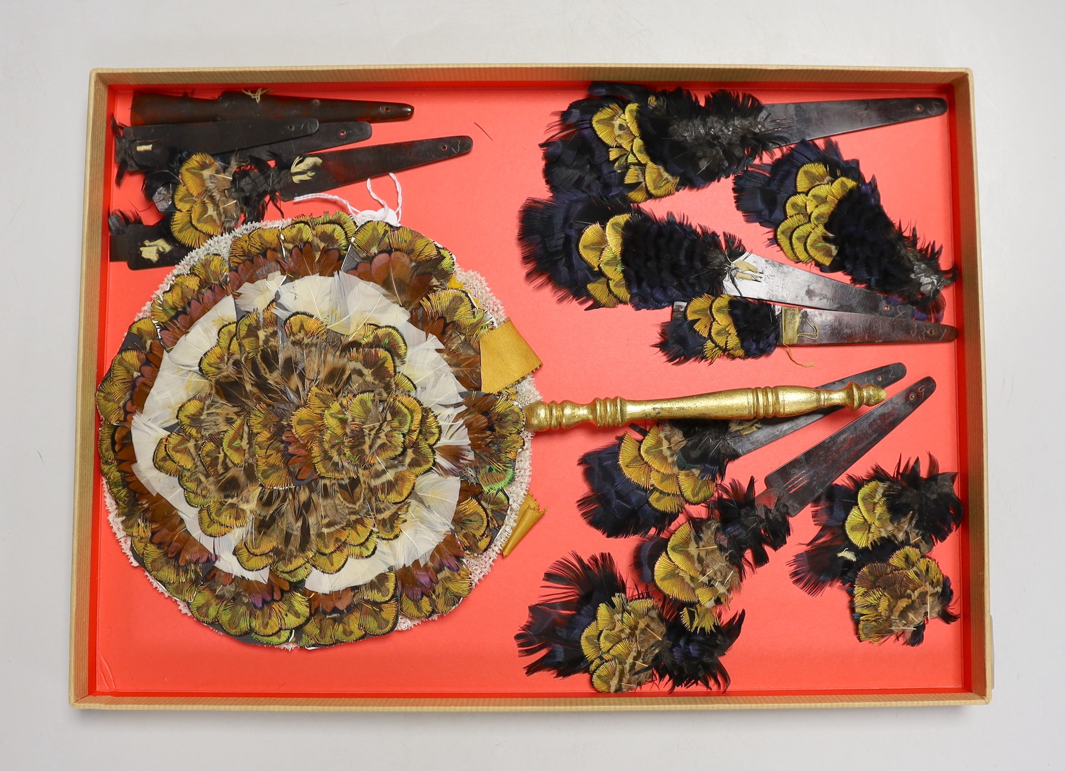 A 19th century feather face fan with gilt painted handle and tortoiseshell fan guards with similar feather mounts